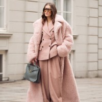 Nina Sandbech wears dust pink suit, Stella McCartney long dusty pink ground touching oversized fake fur coat, orange sunglasses and grey bag during...