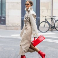 Nina Sandbech wears trench jacket and beige skirt Helsa, red ankle boots shoes Jimmy Choo, red bag Ferragamo, sunglasses Loewe, earrings, golden...