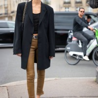 Nora Attal wears a black tank top, black long blazer, tan skinny jeans and black shoes, outside Chanel, during the Haute Couture Fall/Winter...