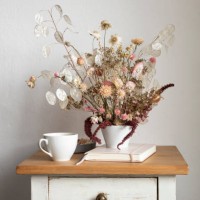 note pad, mug and arrangement of dried flowers on small cabinet - home decoration stock pictures, royalty-free photos & images