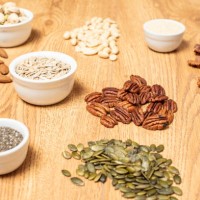 nuts and seeds on a table - food stock pictures, royalty-free photos & images