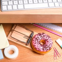 obesity issues doughnut hidden in desk drawer - junk food stockfoto's en -beelden