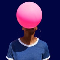 obscured face of woman blowing balloon - fashion stock pictures, royalty-free photos & images