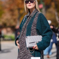 October 1 : Linda Tol wears black sunglasses, dark gray white pattern dark green tweed Chanel coat, light gray quilted Chanel leather bag, black...