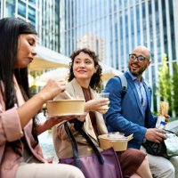 office workers eating lunch together - junk food stock pictures, royalty-free photos & images
