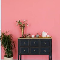 old chest of drawers with objects on the background of a pink wall. next is a flower in a pot. beautiful interior in vintage style. - home decoration stock pictures, royalty-free photos & images