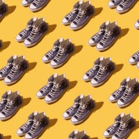 old style worn blue basketball shoe pattern on yellow background. fashion, modern, retro and casual footwear concept. - fashion photos et images de collection