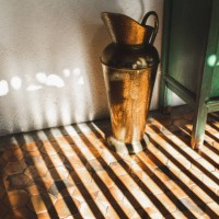 old vintage bronze vase in beautiful sun light. house decoration - home decoration stockfoto's en -beelden