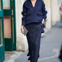 Olivia Palermo wear navy blue long sleeve shirt, black loose low slit maxi skirt, black white polka handbag, gold chain necklace, white open toe...