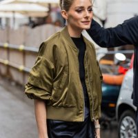 Olivia Palermo wears black laced dress, green bomber jacket outside Del Core during the Milan Fashion Week Menswear Spring/Summer 2025 on September...