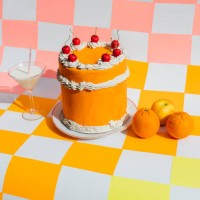 orange cake with milk cocktail and citric fruit on multicolored checkered background - food stock pictures, royalty-free photos & images