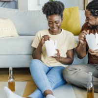 ordering and eating fast food meal at home - junk food stock pictures, royalty-free photos & images