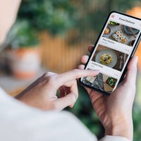 ordering food online at home with smartphone - junk food stock pictures, royalty-free photos & images