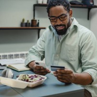 ordering food online while working from home - junk food stock pictures, royalty-free photos & images