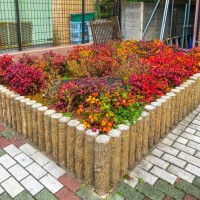 otafukunanten in flowerbed at a corner of the street - garden decoration stock pictures, royalty-free photos & images