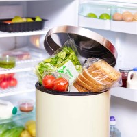 out of date food in garbage bin in-front fridge - food stock pictures, royalty-free photos & images