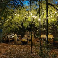 outdoor garden lounge under bamboo at night with a light garland - garden decoration stock pictures, royalty-free photos & images