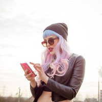 outdoor portrait of blue-pink hair cool girl texting on phone - fashion stock pictures, royalty-free photos & images