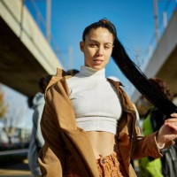 outdoor portrait of early 20s woman with long black ponytail - fashion stock pictures, royalty-free photos & images