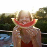 outdoor portrait of laughing young woman enjoying watermelon - food stock pictures, royalty-free photos & images