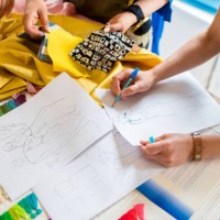 overhead view of a team of fashion designers working - fashion stock pictures, royalty-free photos & images