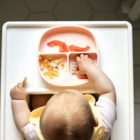 overhead view of infant baby eating in the table for feeding. - food stock pictures, royalty-free photos & images