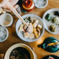 overhead view of woman enjoying delicate japanese cuisine with various side dishes and green tea in the restaurant - food stock pictures, royalty-free photos & images