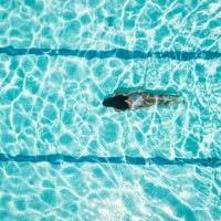 overhead view on girl idiving in swimming pool - fashion stock pictures, royalty-free photos & images