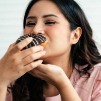 overweight happy woman with a donut - junk food stock pictures, royalty-free photos & images