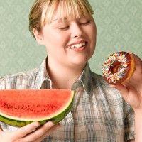 overweight teenage girl with water melon - junk food stockfoto's en -beelden