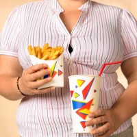 overweight teenager with fries - junk food stock pictures, royalty-free photos & images