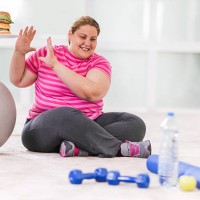 overweight woman refusing hamburger. - junk food stock pictures, royalty-free photos & images