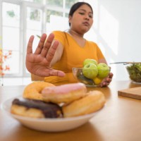 overweight woman refusing unhealthy food. - food stock pictures, royalty-free photos & images