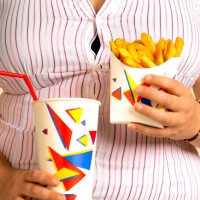 overweight woman with take out fast food - junk food stock pictures, royalty-free photos & images