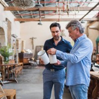 owner of antique shop talking with customer in his store - home decoration stock pictures, royalty-free photos & images