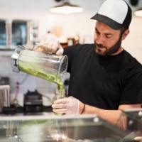 owner working in zero waste oriented grocery and take out food store. - junk food stock pictures, royalty-free photos & images