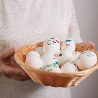 painted easter eggs in wicker plate in hands of older woman - nails art stock pictures, royalty-free photos & images