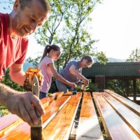 painting together can be fun - family painting wooden fence boards outdoors on a sunny summer day - home decoration stock pictures, royalty-free photos & images