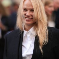 Pamela Anderson is seen outside The Row show wearing a white shirt and black blazer during the Womenswear Spring/Summer 2024 as part of Paris Fashion...