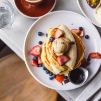 pancakes with banana, strawberry and blueberry served in a cafe for breakfast, high angle view - food stock pictures, royalty-free photos & images
