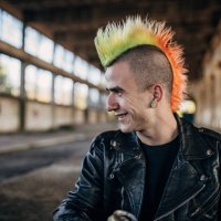 panker with colorful coiffure sitting in abandoned warehouse and drinking beer - hairstyle stock pictures, royalty-free photos & images