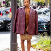 Paola Lacatelli wears burgundy jacket, brown bag, skirt, jacket outside Miu Miu during the Womenswear Spring/Summer 2024 as part of Paris Fashion...