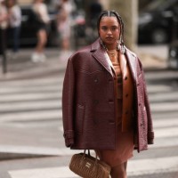 Paola Locatelli is seen wearing a cognac leather jacket, a red-brown oversized leather jacket, an orange dress and a brown Arcadie Miu Miu handbag...