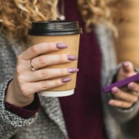 paper cup and mobile phone in hand - junk food stock pictures, royalty-free photos & images
