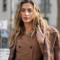 Paris Jackson wears a brown oversized checkered blazer jacket, a brown leather double breasted short coat worn as a mini dress, before Stella...