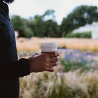 part of a man holding a disposable cup of coffee - junk food stock pictures, royalty-free photos & images