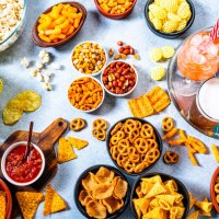 party table with salty snacks and drinks shot from above - junk food stock pictures, royalty-free photos & images