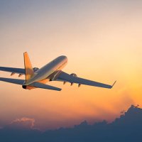passenger airplane flying above clouds during sunset - travel stock pictures, royalty-free photos & images