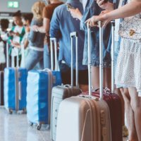 passengers with luggage waiting in line at airport - travel stock pictures, royalty-free photos & images