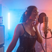 passionate young adult black female singing in a beautiful recording studio - concert stock pictures, royalty-free photos & images